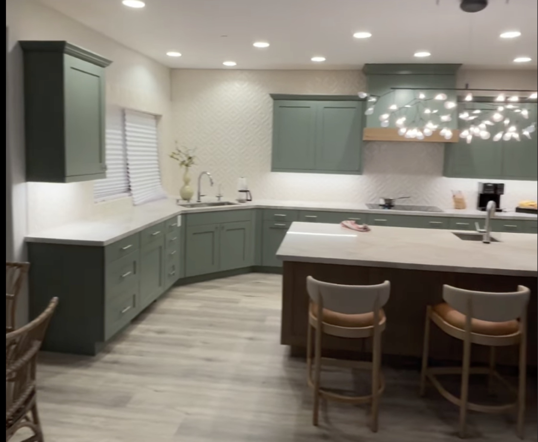 Finished green kitchen with recessed and decorative lighting